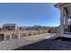 Landscaped backyard with rock ground cover, a wood fence and green grass at 8760 Ginkgo Loop, Parker, CO 80134