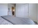 Comfortable bedroom featuring neutral tones, soft carpeting, and a gray patterned comforter at 8760 Ginkgo Loop, Parker, CO 80134