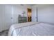 Comfortable bedroom featuring soft neutral walls, soft carpeting, and a comfy bed with a white patterned comforter at 8760 Ginkgo Loop, Parker, CO 80134