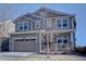 Two-story home boasts a neutral color scheme and attached two car garage at 8760 Ginkgo Loop, Parker, CO 80134