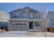 Two-story home boasts a neutral color scheme and attached two car garage at 8760 Ginkgo Loop, Parker, CO 80134