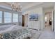 Spacious main bedroom features a beautiful chandelier, neutral walls and an en-suite bathroom at 8760 Ginkgo Loop, Parker, CO 80134