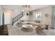 Cozy living room with plush carpet, a comfortable sectional sofa, and a staircase visible in the background at 22255 E Mansfield Pl, Aurora, CO 80018