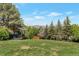 Picturesque backyard with a cozy gazebo, mature trees, and scenic mountain views in the distance at 251 Norse St, Golden, CO 80401