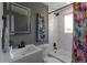 Bright bathroom featuring a modern vanity, marble tile shower, and stylish fixtures at 251 Norse St, Golden, CO 80401