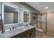 Updated bathroom featuring double sinks, modern mirrors, and a glass shower at 251 Norse St, Golden, CO 80401