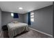 Comfortable bedroom with neutral carpet, two windows, and gray walls at 251 Norse St, Golden, CO 80401