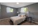 Cozy bedroom with plush carpet, neutral tones, and natural light from two windows at 251 Norse St, Golden, CO 80401