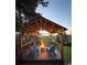 Evening view of the backyard gazebo featuring comfortable seating around a fire pit at 251 Norse St, Golden, CO 80401