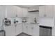 Modern kitchen with stainless steel appliances, white cabinets and quartz countertops at 251 Norse St, Golden, CO 80401