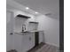 Stylish wet bar with floating shelves, undermount sink, and sleek black fixtures at 251 Norse St, Golden, CO 80401