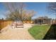 This backyard includes grass, a patio, gravel, mature trees, and a shed at 851 Quitman St, Denver, CO 80204