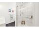 Bright bathroom featuring a tiled shower with glass door and modern fixtures at 851 Quitman St, Denver, CO 80204