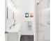 Clean bathroom with double vanity, modern fixtures, and a tiled shower with glass door at 851 Quitman St, Denver, CO 80204