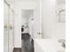 Contemporary bathroom with walk-in shower, and views to laundry at 851 Quitman St, Denver, CO 80204