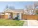 Attractive home with a cozy front porch, privacy fence and manicured greenery at 851 Quitman St, Denver, CO 80204