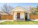 Inviting front porch on this home with tidy lawn and wood fencing at 851 Quitman St, Denver, CO 80204
