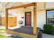 Close up of the front porch with a chair and view of the front door and address at 851 Quitman St, Denver, CO 80204