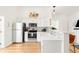 Modern kitchen with white cabinets, stainless steel appliances, and stylish backsplash for a clean look at 851 Quitman St, Denver, CO 80204