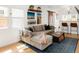 Cozy living room with a comfortable sectional sofa, wooden accents, and bright natural light at 851 Quitman St, Denver, CO 80204