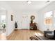Inviting living room featuring hardwood floors, a bright white door and natural light at 851 Quitman St, Denver, CO 80204