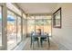Bright sunroom features large windows, tile flooring, dining table and backyard views at 851 Quitman St, Denver, CO 80204