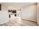 Open concept dining area with wood-look flooring and access to the kitchen at 27413 E 1St Pl, Aurora, CO 80018