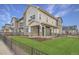 Modern two-story townhome with stone accents and a landscaped lawn at 27413 E 1St Pl, Aurora, CO 80018