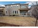 View of the home's backyard with a lawn and a covered back porch at 887 Sundance Ln, Erie, CO 80516