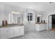 Bathroom featuring dual sinks, granite countertops, and a marble tile floor at 887 Sundance Ln, Erie, CO 80516