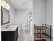 Bathroom vanity with stone countertop and walk-in shower at 887 Sundance Ln, Erie, CO 80516