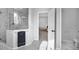Modern bathroom featuring a glass-enclosed shower and sleek marble countertops at 887 Sundance Ln, Erie, CO 80516