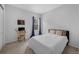 Serene bedroom with neutral walls, a comfortable bed, a workspace, and a window providing natural light at 887 Sundance Ln, Erie, CO 80516