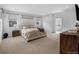 Neutral bedroom featuring large windows, soft carpet, ensuite bathroom, and a TV for ultimate comfort and relaxation at 887 Sundance Ln, Erie, CO 80516