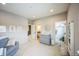 Large bedroom with three windows, a gray couch, and access to the closet and bathroom at 887 Sundance Ln, Erie, CO 80516