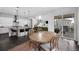 Open-concept dining room next to the kitchen with hardwood floors and a round wooden table at 887 Sundance Ln, Erie, CO 80516