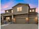 Beautiful two-story home with stone veneer and neutral siding, showcasing a welcoming front porch and an attached two-car garage at 887 Sundance Ln, Erie, CO 80516