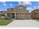 Beautiful two-story home with a stone and siding facade, a two-car garage, and a well-maintained lawn at 887 Sundance Ln, Erie, CO 80516