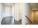 Hallway with a staircase and doorway to a room featuring hard wood flooring at 887 Sundance Ln, Erie, CO 80516