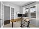 Bright home office with modern desk, dual monitors, and ample natural light through the windows at 887 Sundance Ln, Erie, CO 80516