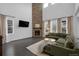 Open-concept living room featuring a stone fireplace and a comfy L-shaped couch at 887 Sundance Ln, Erie, CO 80516