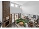 Bright living room with a stone fireplace and an open-concept design, offering a seamless flow to other spaces at 887 Sundance Ln, Erie, CO 80516