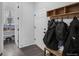 Mudroom with storage cubbies, hooks, and convenient access to a pantry for easy organization and storage at 887 Sundance Ln, Erie, CO 80516