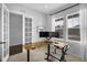 Bright office space featuring a corner desk, a barn door and two large windows at 887 Sundance Ln, Erie, CO 80516
