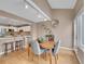 Dining area featuring hardwood floors, modern lighting, seating for four, and an adjacent kitchen at 9200 E Cherry Creek South Dr # 29, Denver, CO 80231