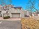 Street view of a two-story home with a covered balcony, garage, and elevated front entry with manicured landscaping at 9200 E Cherry Creek South Dr # 29, Denver, CO 80231