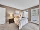 Comfortable main bedroom with neutral tones featuring large window and outdoor access to the balcony at 9200 E Cherry Creek South Dr # 29, Denver, CO 80231