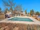 Community pool with cover in place next to tennis courts and a community building at 9200 E Cherry Creek South Dr # 29, Denver, CO 80231