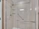 Modern shower featuring glass doors, a rain shower head, and convenient grab bars for accessibility at 9200 E Cherry Creek South Dr # 29, Denver, CO 80231