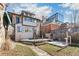 A large backyard with a wooden deck and a brick pathway leading to the yard at 1451 N Gilpin St, Denver, CO 80218